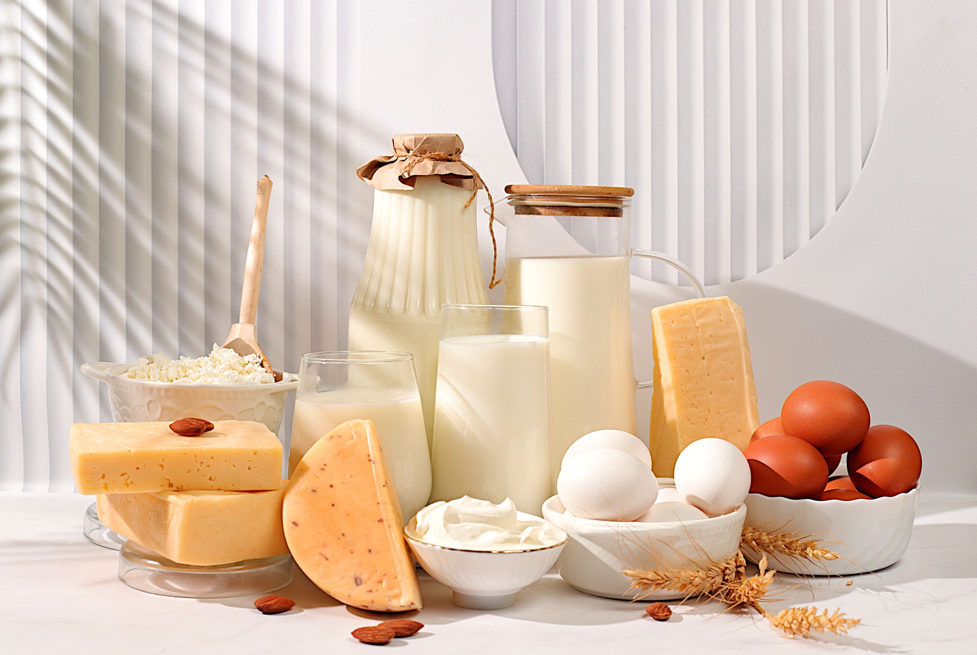 Assortment of fresh dairy products, milk, cottage cheese, cheeses, eggs and sour cream on the kitchen table, the concept of natural nutrition, maintaining healthy intestinal microflora, dietary nutrition.